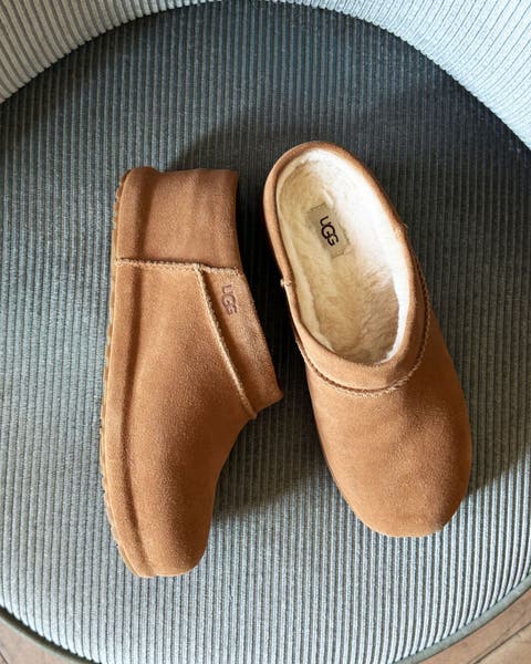 A pair of tan suede Ugg slip ons.