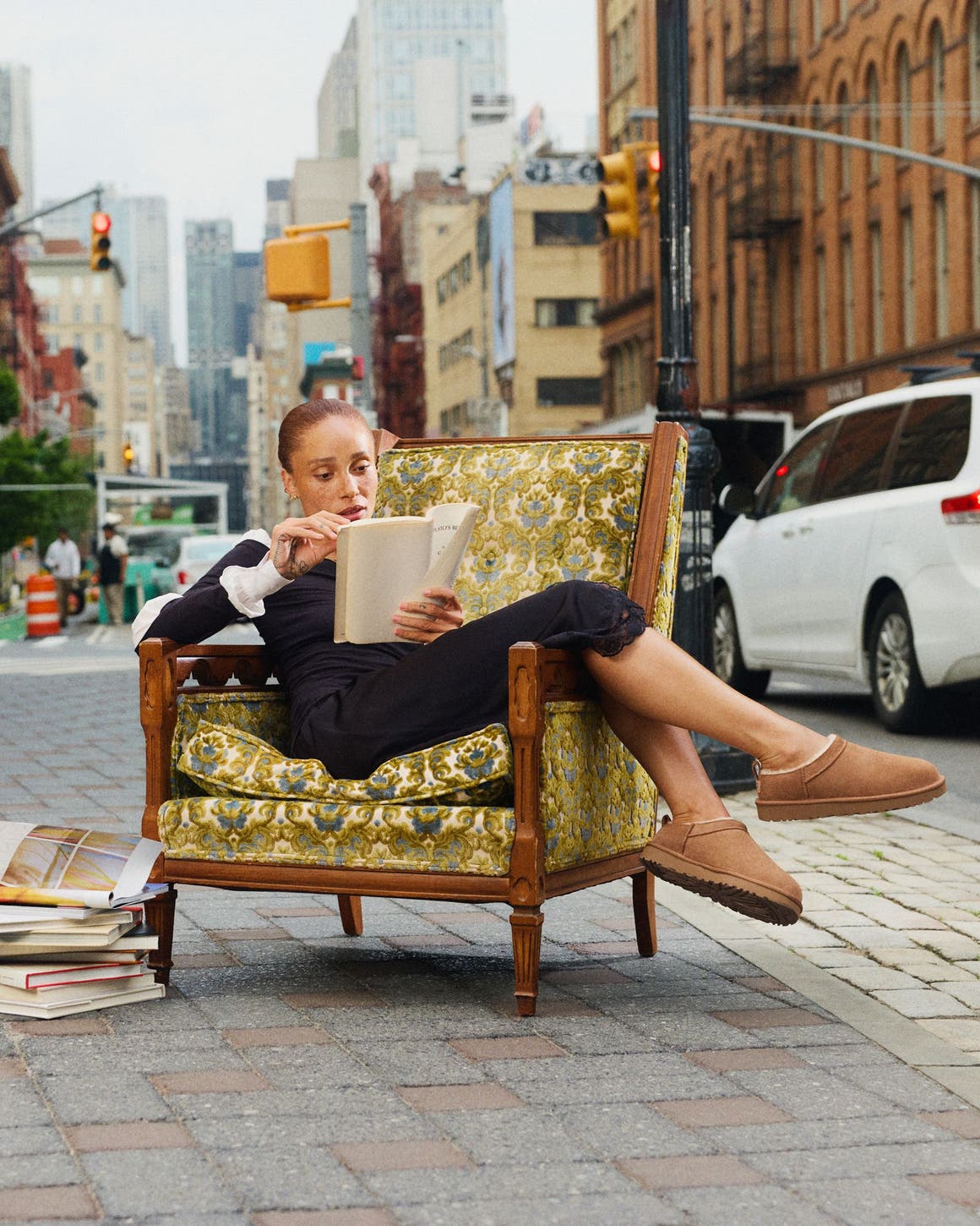 Girl sitting in chair on the sidewalk in UGG shoes