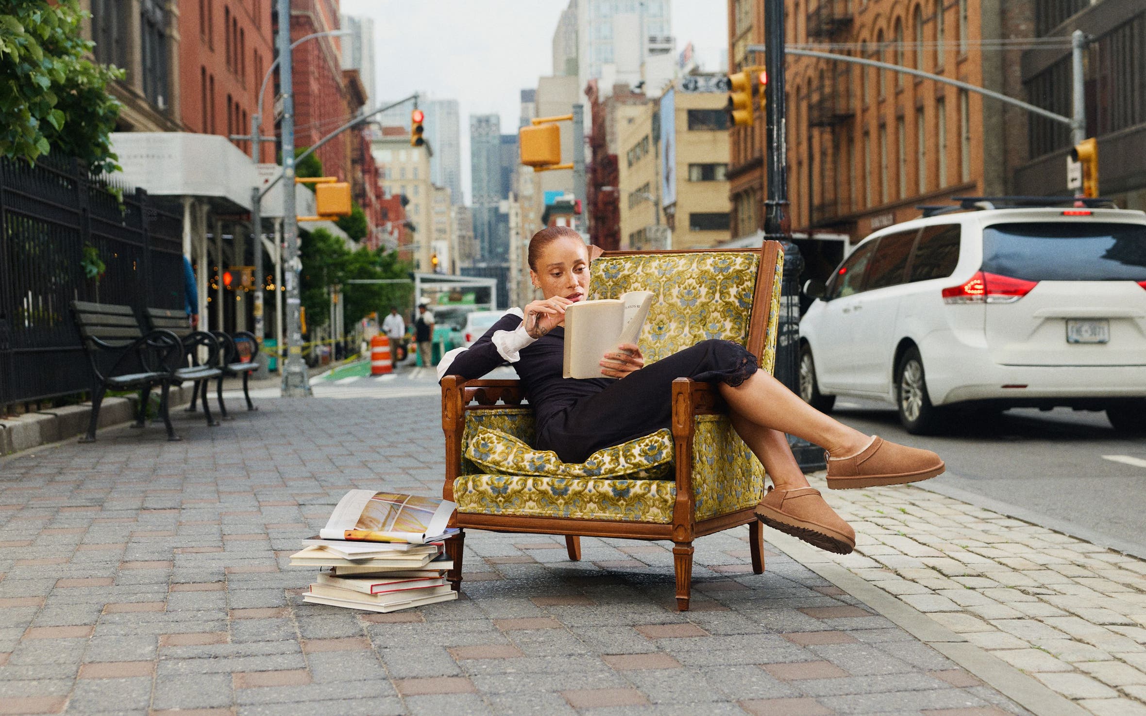 Girl sitting in chair on the sidewalk in UGG shoes