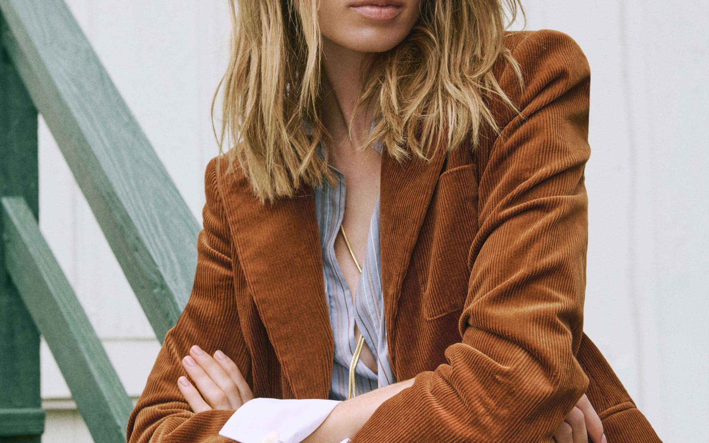 A woman in a brown corduroy blazer.
