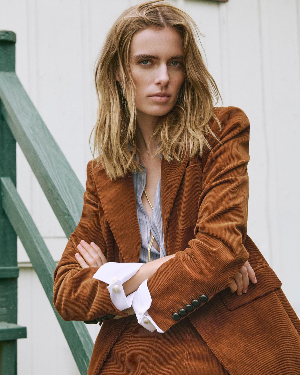 A woman in a brown corduroy blazer.