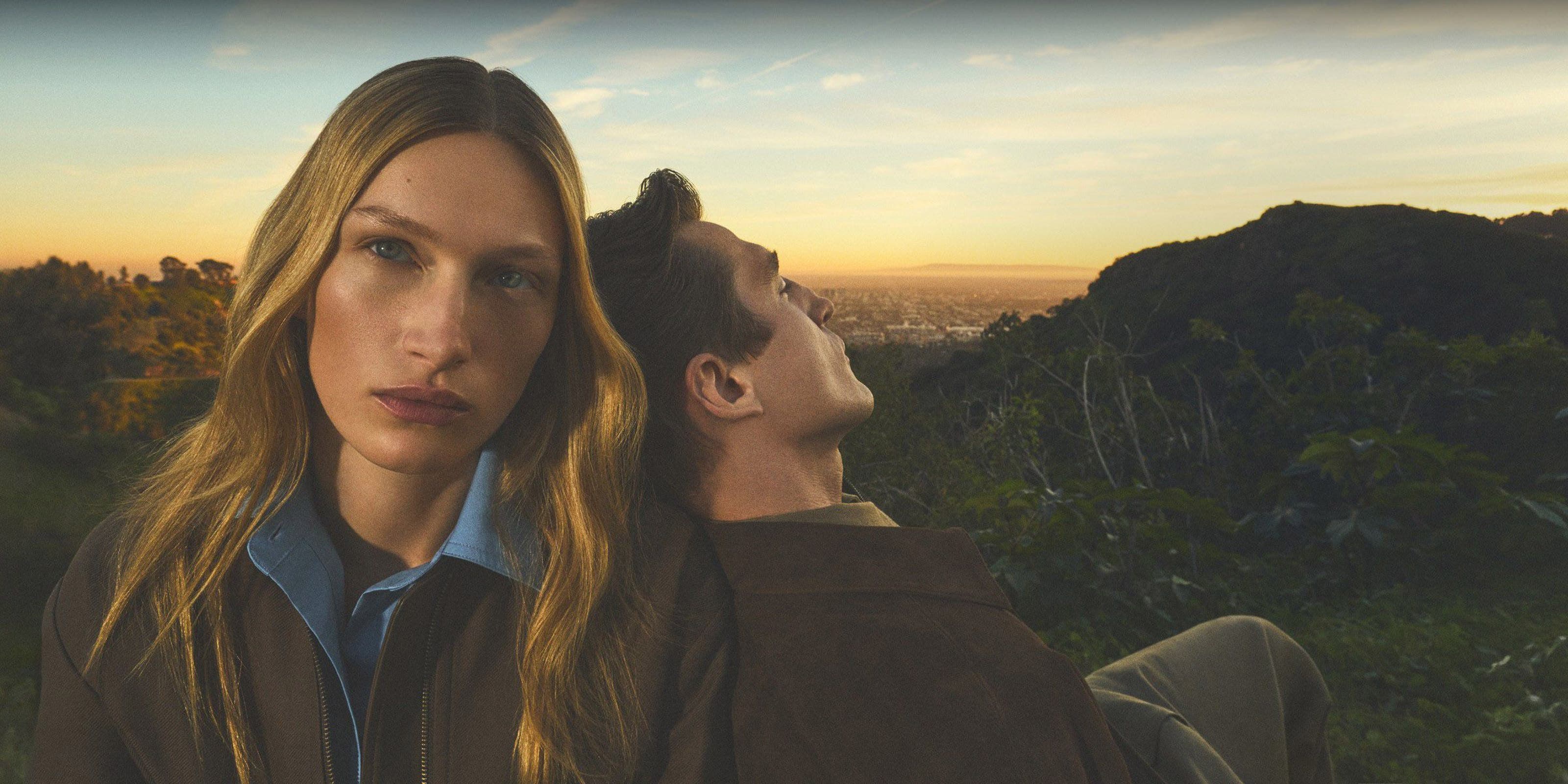 Man leaning his back on a woman wearing Vince collection.