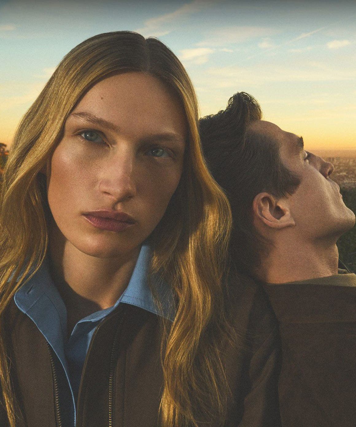 Man leaning his back on a woman wearing Vince collection.