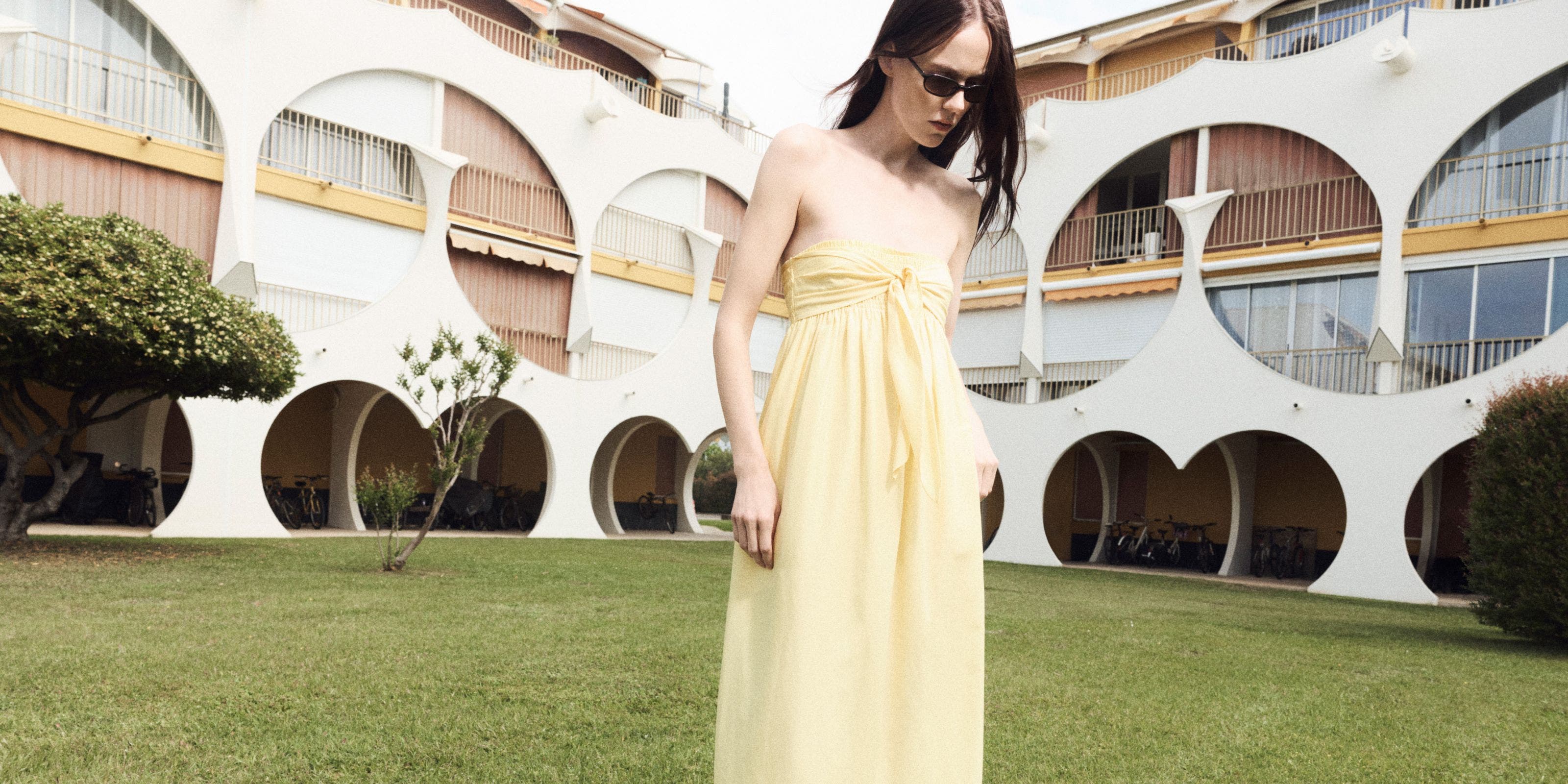 Woman wearing a yellow Vince dress.