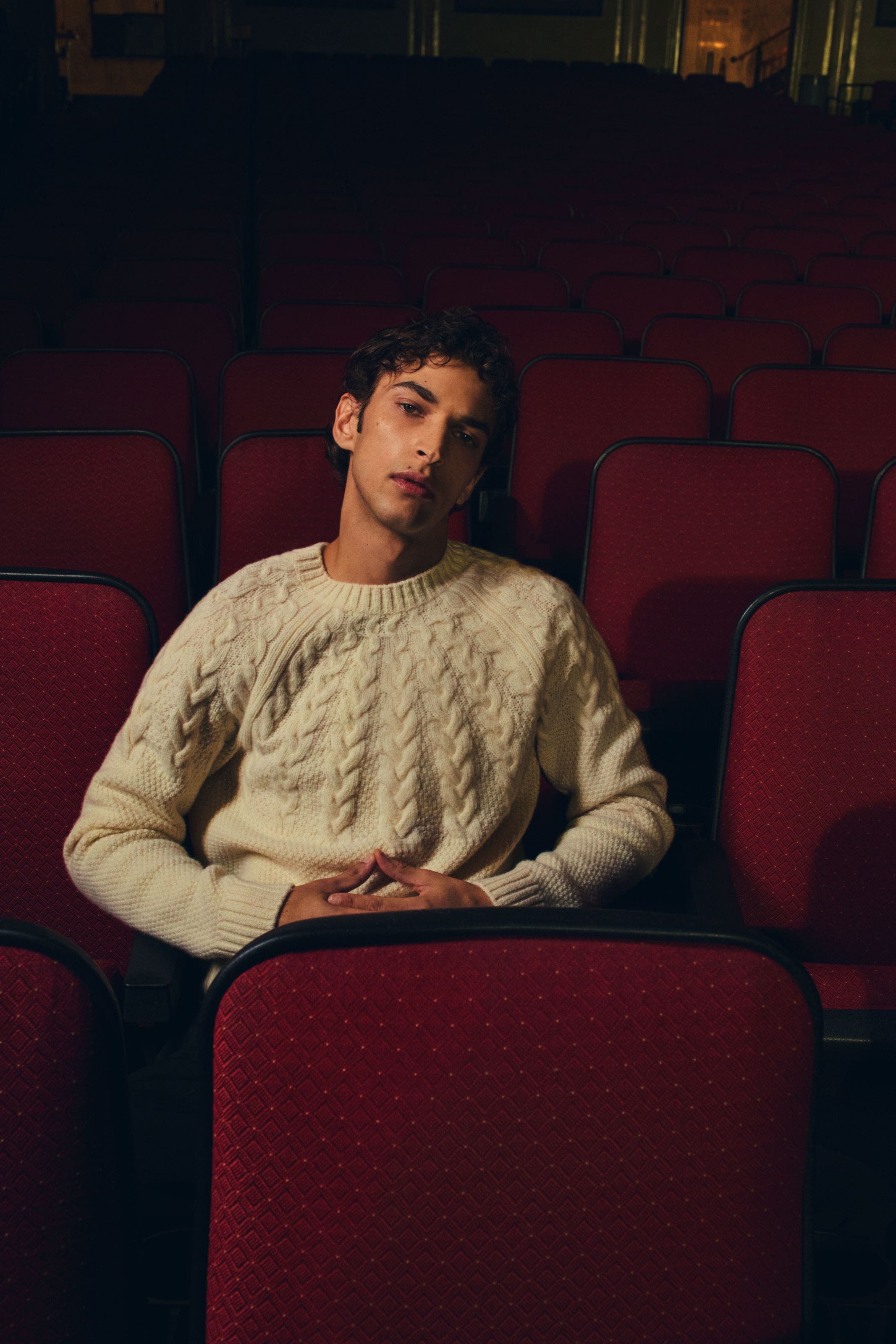 Man wearing a knit Vince sweater.