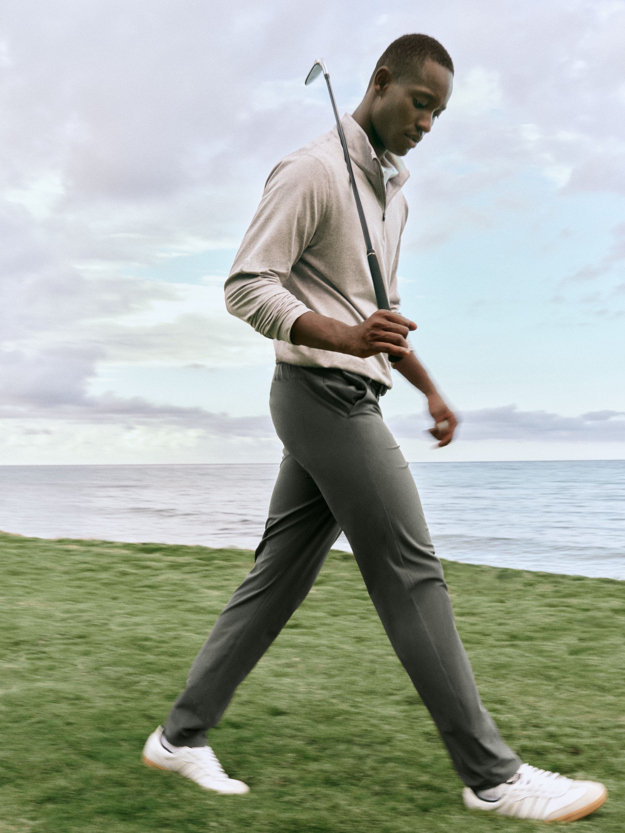 A man walking with a golf club