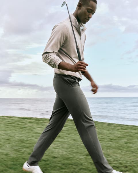 A man walking with a golf club