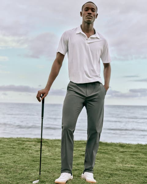 A man wearing a polo shirt and pants.