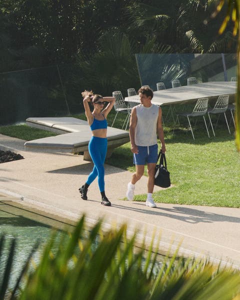 Man and woman walking wearing Vuori clothing.