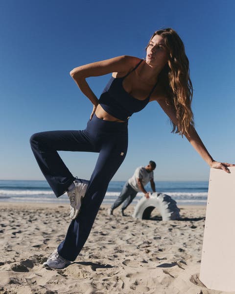 Woman wearing Vuori clothing on a beach.