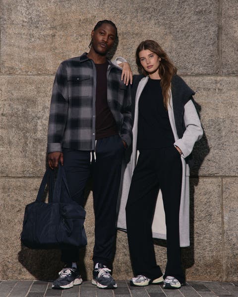 Man and woman wearing Vuori travel apparel.