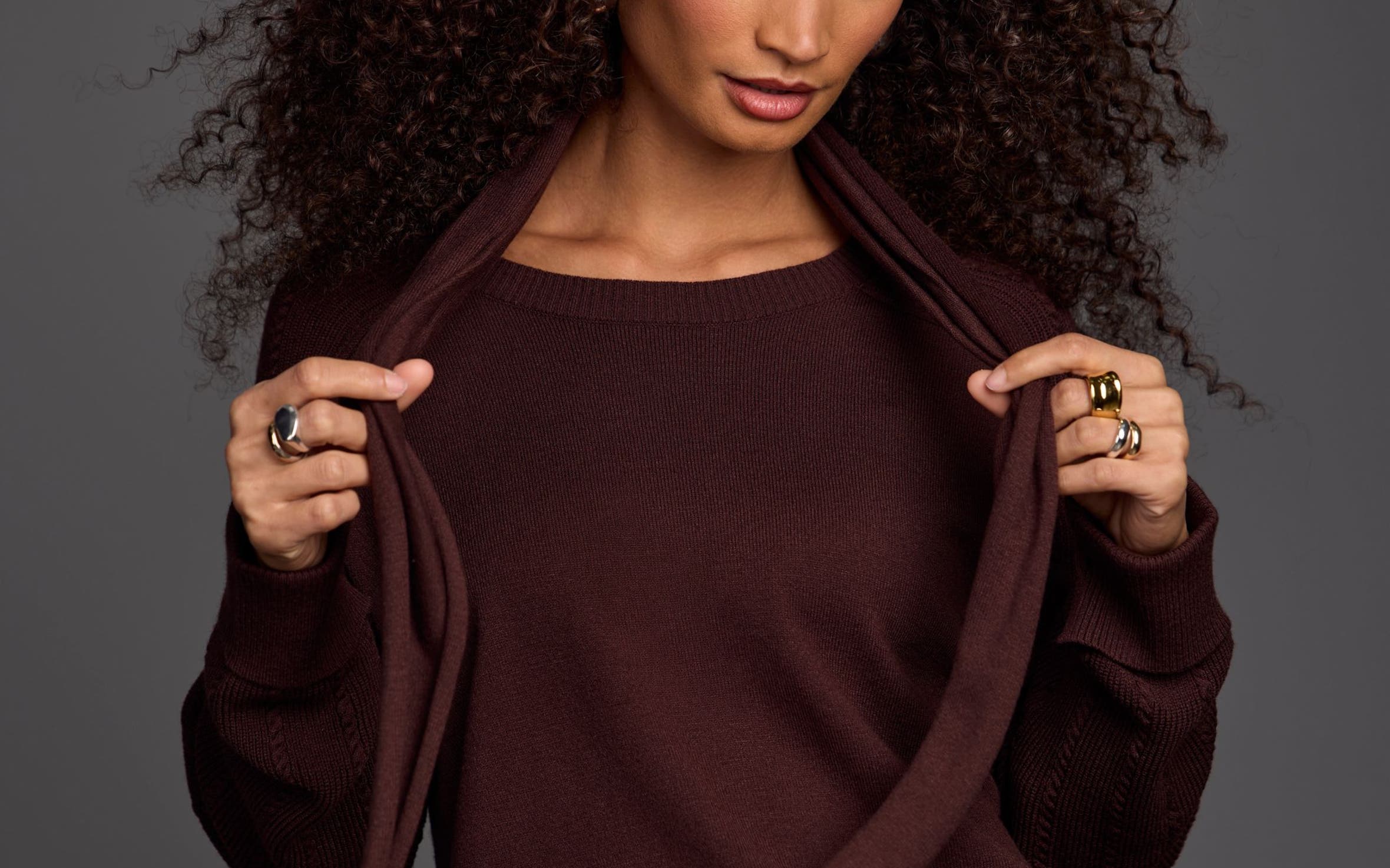 Woman wearing a brown sweater.