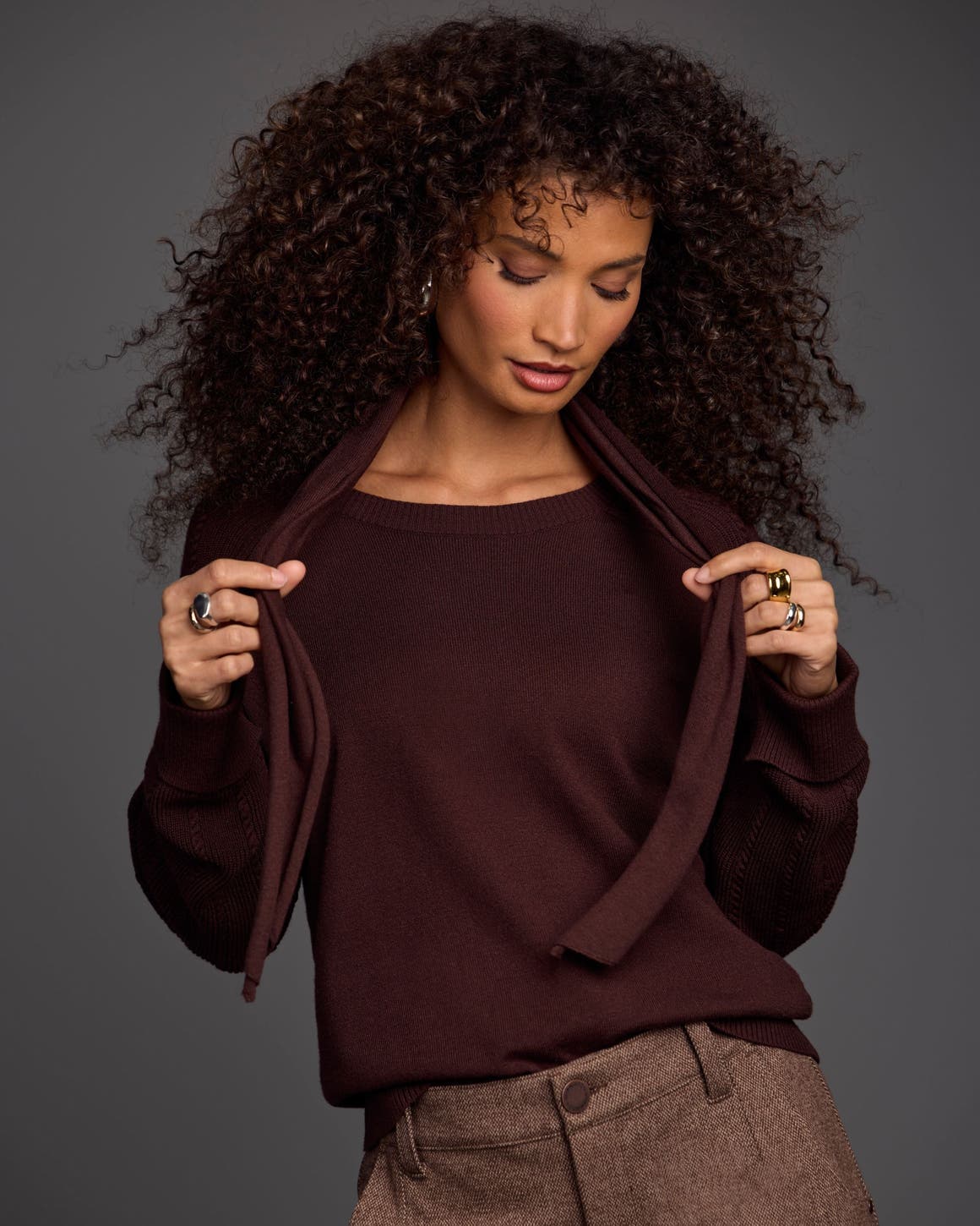 Woman wearing a brown sweater.