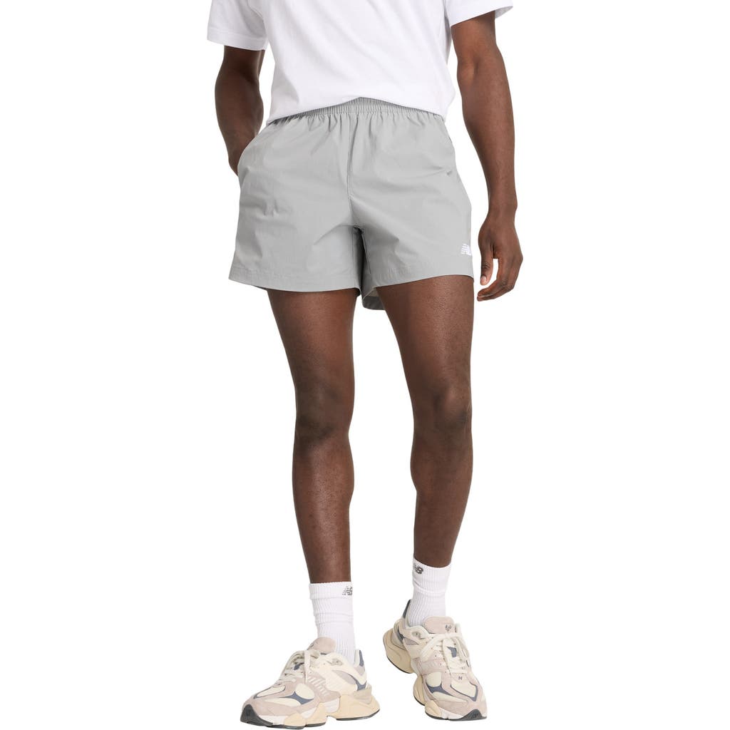 NEW BALANCE NEW BALANCE ATHLETICS WOVEN STRETCH NYLON SHORTS