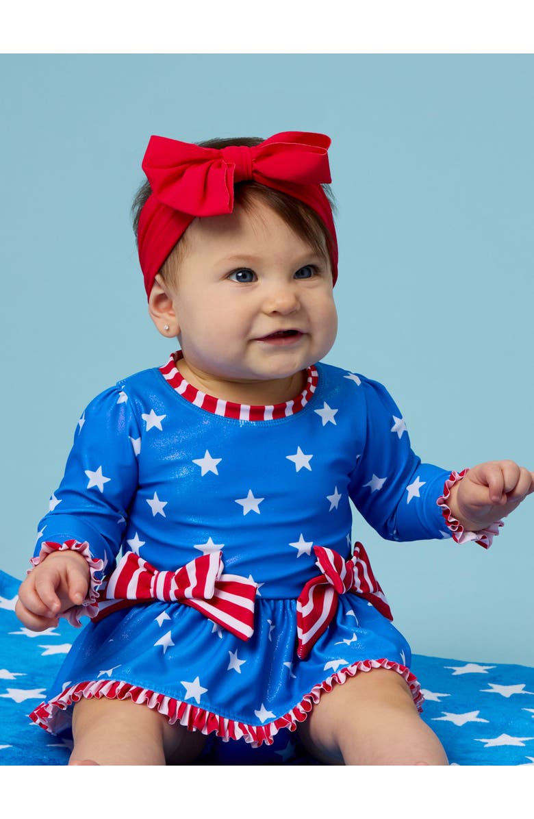 RuffleButts UPF50+ Long Sleeve One Piece Bow Peplum Rash Guard Swimsuit, Alternate, color, Shimmer Stars & Stripes