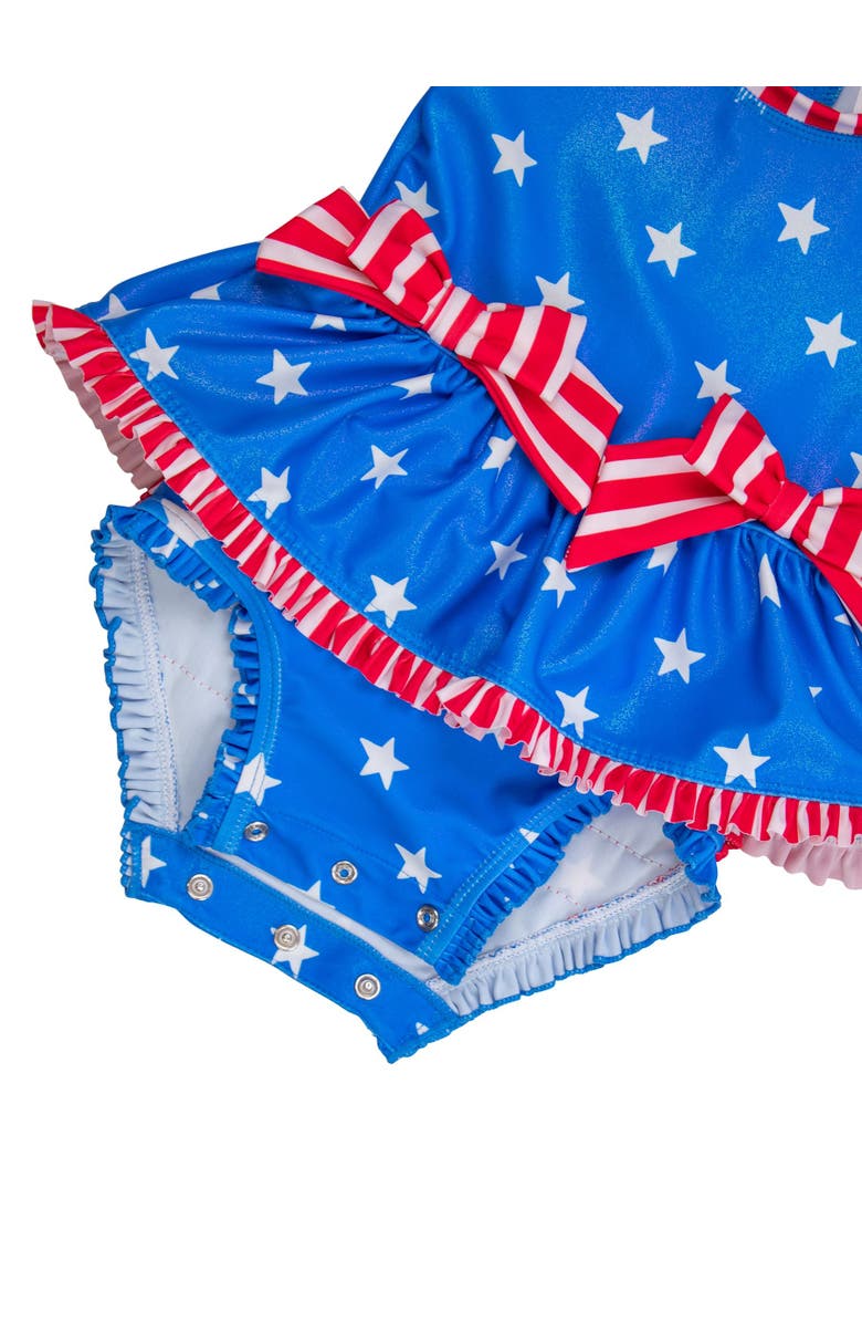 RuffleButts UPF50+ Long Sleeve One Piece Bow Peplum Rash Guard Swimsuit, Alternate, color, Shimmer Stars & Stripes