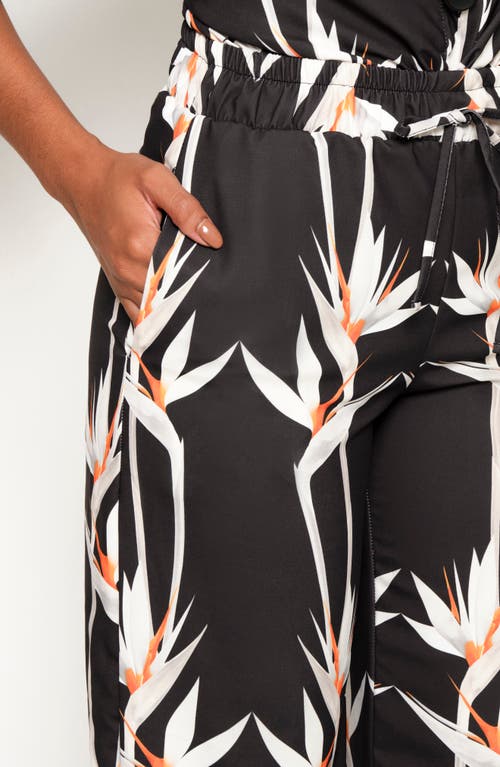 The Lulo Project Floral Ruffle Hem Drawstring Pants In Birds Of Paradise Black