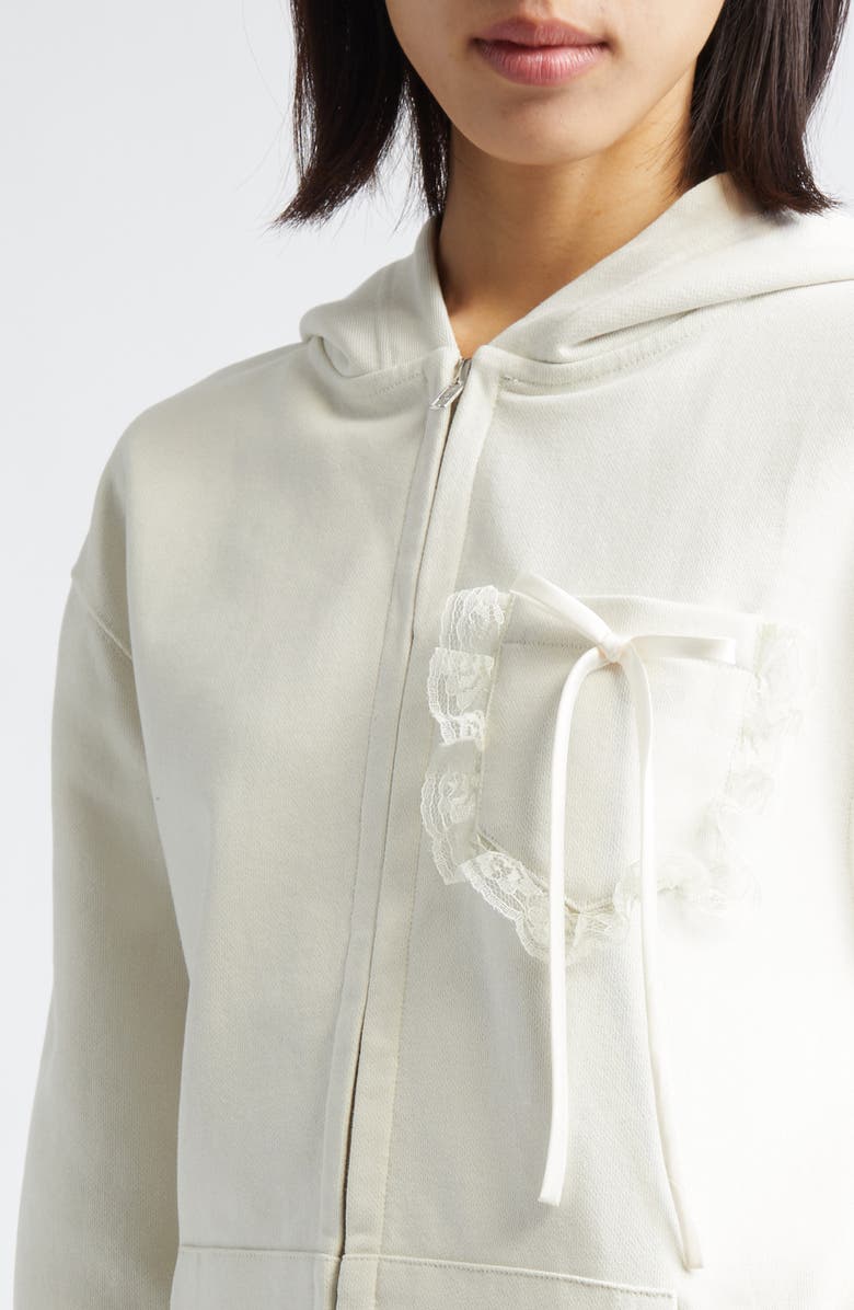 Tanner Fletcher Gender Inclusive Bennett Bow Pocket Cotton Zip-Up Hoodie, Alternate, color, Ivory