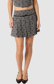 All in Favor Flocked Bow Pleated Miniskirt