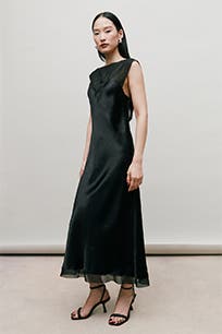 A woman wearing a black cocktail dress.