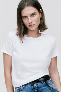 A woman wearing a white crewneck T-shirt. 