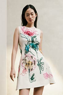 A woman wearing a floral dress.