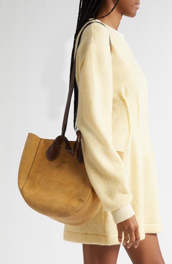 【送料&関税込】J.W. Anderson Beige Suede Small Punch Handba J.W. Anderson Beige Suede Small Punch Handbag | italist