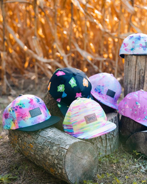 DEUX PAR DEUX DEUX PAR DEUX BABY GIRL'S PRINTED CAP BUTTERFLIES ON MULTICOLORED AND BLACK BACKGROUND