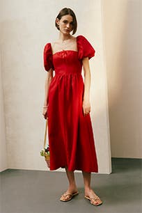 A woman wearing a red midi dress. 