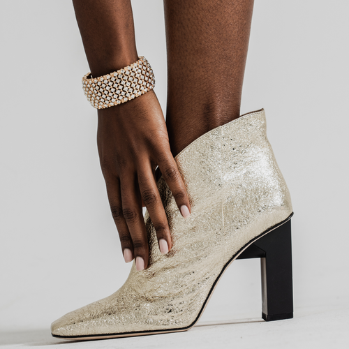 Tiannia Barnes Sancy Ankle Bootie In Gold