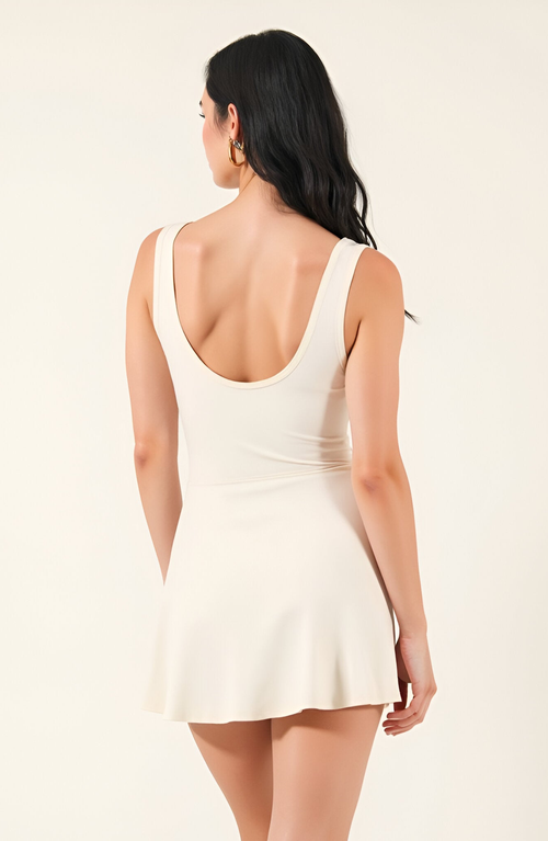 Modenaire Sleeveless Active Romper With Side Tie Skirt Overlay And Crew Neckline In White