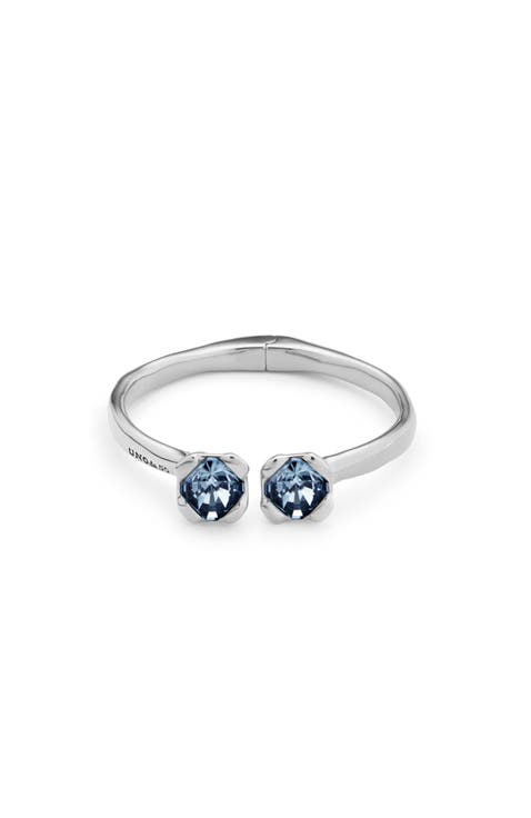 Sterling silver-plated bangle bracelet with inner spring and two blue crystals