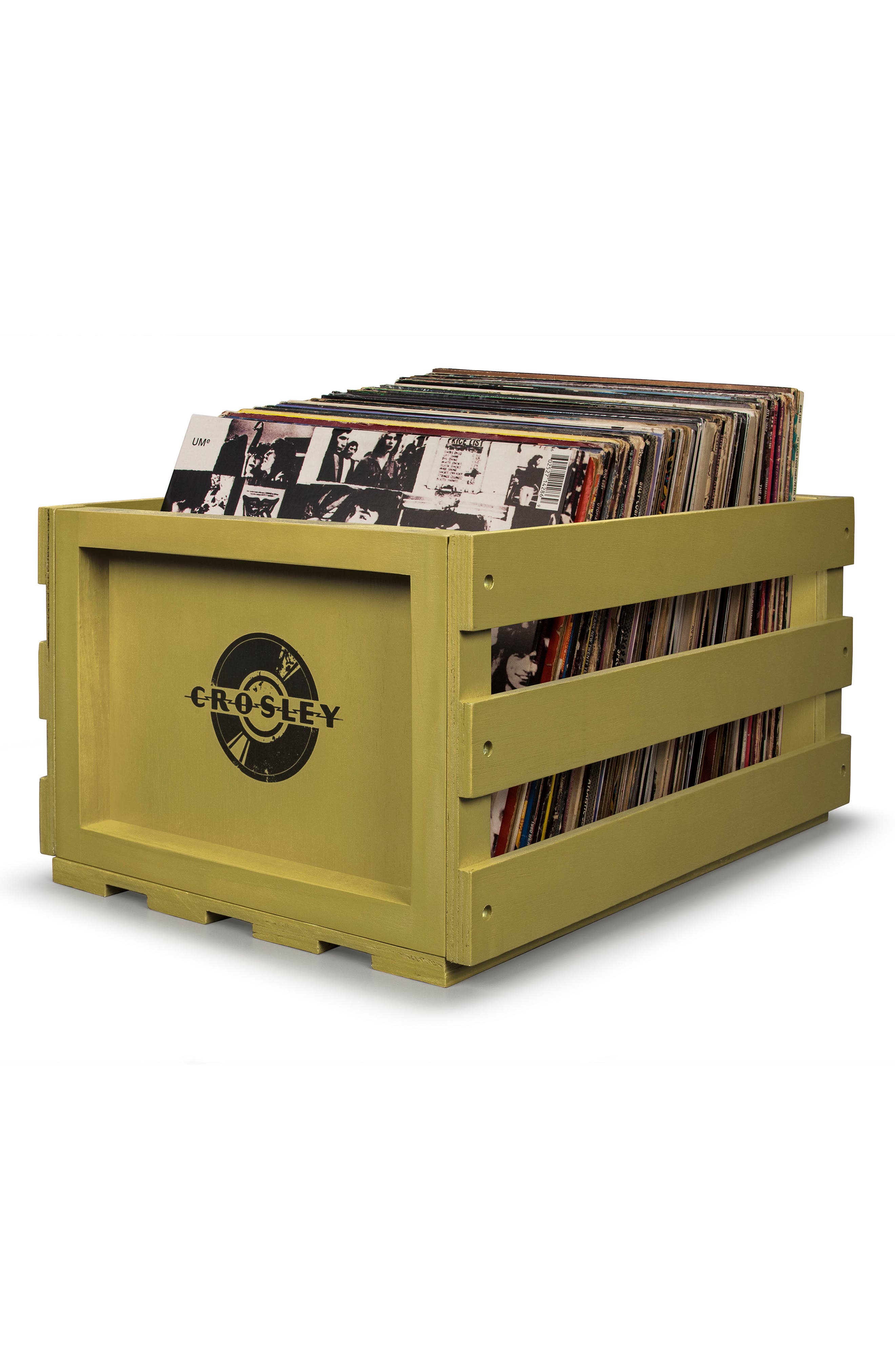 A light olive/yellow wooden crate filled with vinyl records, Crosley logo on the side.