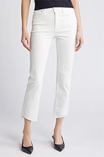 A woman wearing white jeans with raw hems.