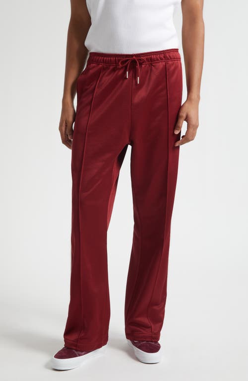 STOCKHOLM SURFBOARD CLUB Monogram Track Pants in Cherry 