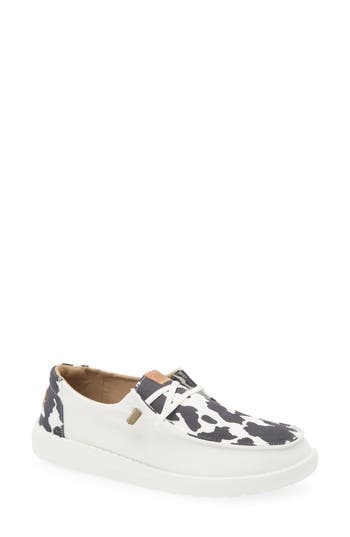 Hey Dude Wendy Animal Print Slip-on Moc Toe Shoe In White/black Cow Print