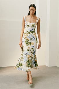 A woman wearing a floral midi dress.
