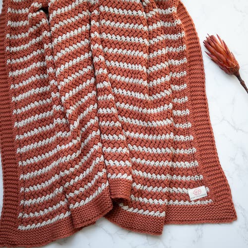 Pink Lemonade Tara Organic Cotton Throw Blanket in Rust 