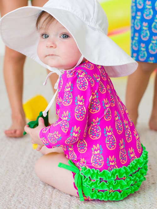 Rufflebutts Baby Girls Long Sleeve Upf50+ One Piece Rash Guard In Neon Violet Pineapples