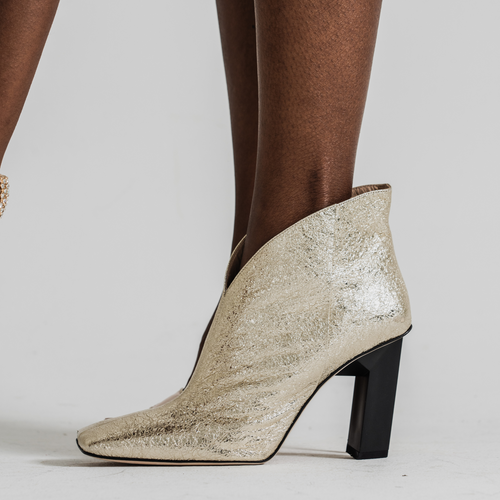 Tiannia Barnes Sancy Ankle Bootie In Gold