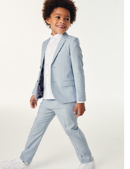 A boy dressed up in a blue suit.