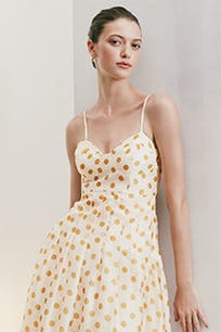 A woman wearing a polka dot fit-and-flare dress.