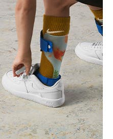 Kid wearing Nike socks and sneakers.