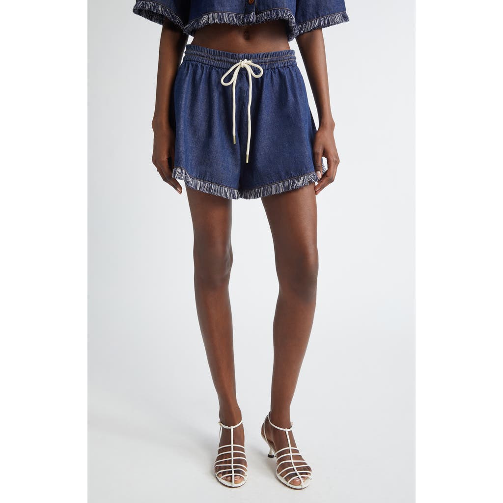 Shop Zimmermann Rhiannon Drawstring Waist Fringe Hem Denim Shorts In Atlantic