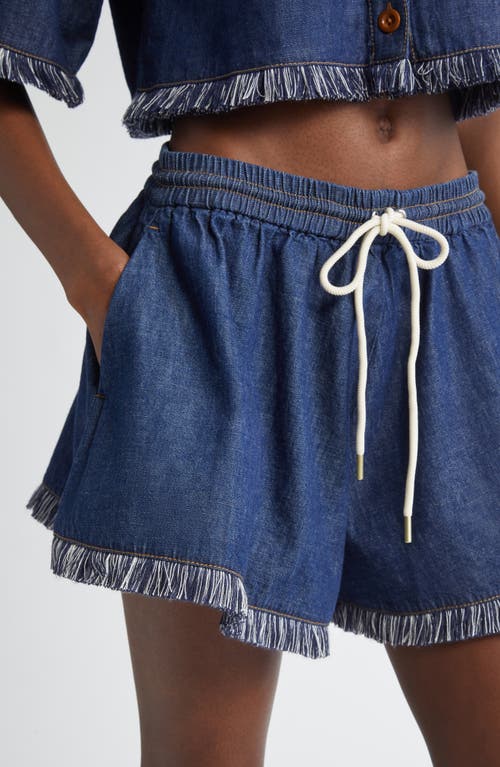 Shop Zimmermann Rhiannon Drawstring Waist Fringe Hem Denim Shorts In Atlantic
