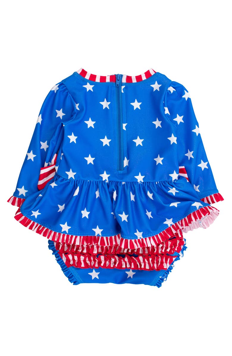 RuffleButts UPF50+ Long Sleeve One Piece Bow Peplum Rash Guard Swimsuit, Alternate, color, Shimmer Stars & Stripes