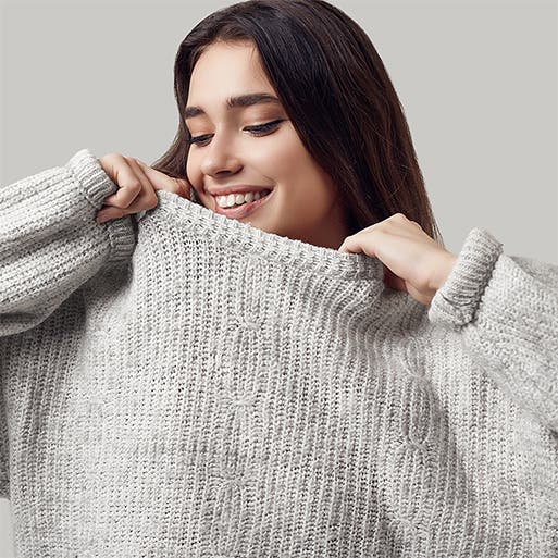 A woman models an oversized sweater.