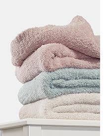A stack of pink, blue and white blankets.