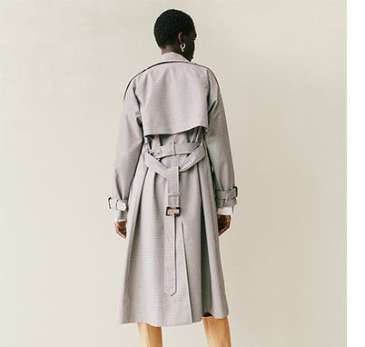 Woman wearing a trench coat.