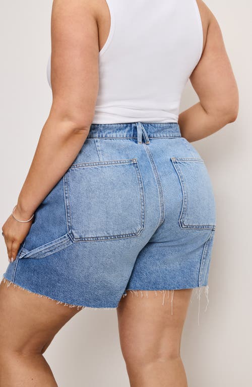 Shop Good American Cutoff Carpenter Denim Shorts In Indigo